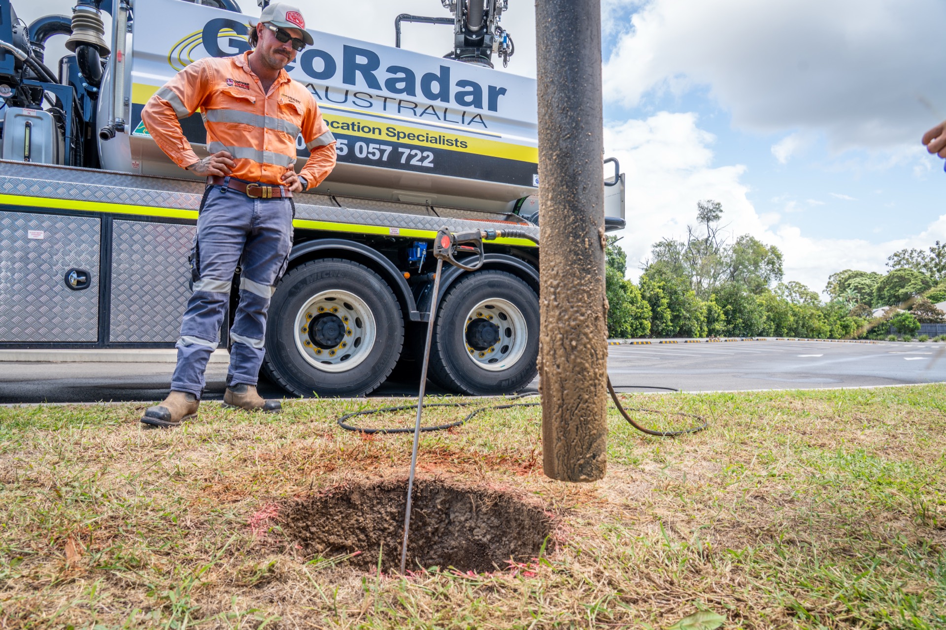 Service potholed cleanly at the base of a power pole