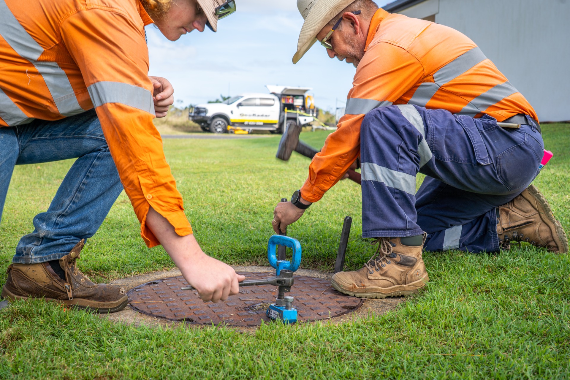 GeoRadar operators tracing a water service with a locator probe